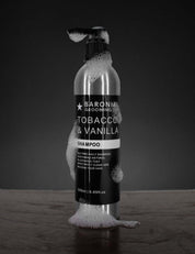 SLS-free shampoo in Tobacco & Vanilla scent on dark rustic background – artisan men’s hair care by Baronial Grooming Co.